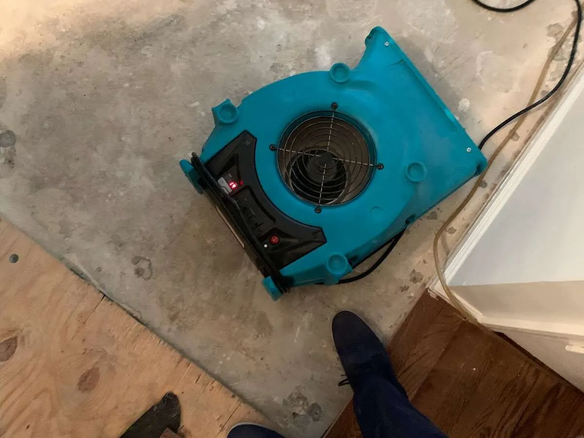 Air mover drying subfloor during Commercial Water Damage Restoration in Laramie